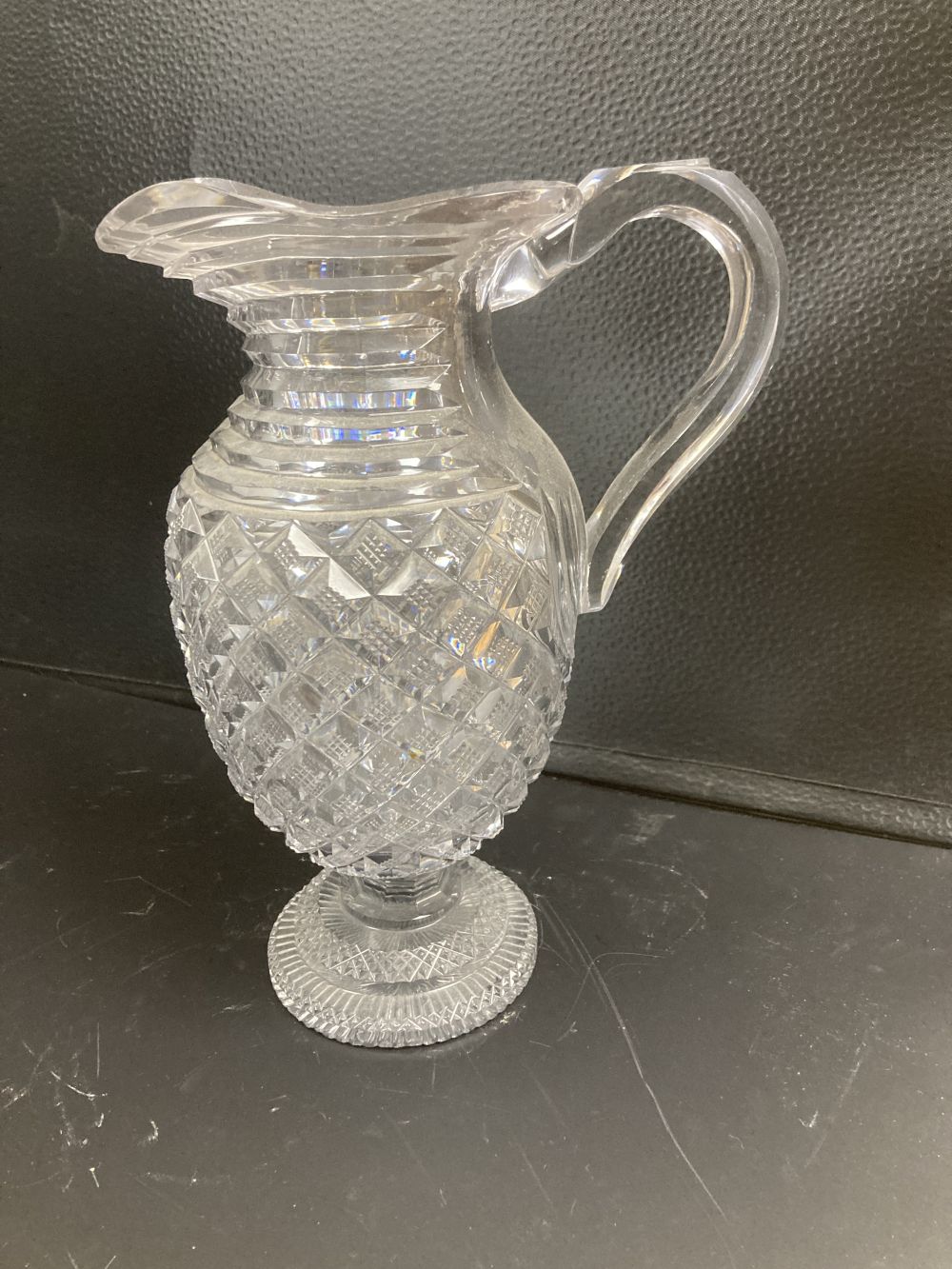 A George IV step and hobnail cut glass ewer, c.1830, 26cm, crack to handle